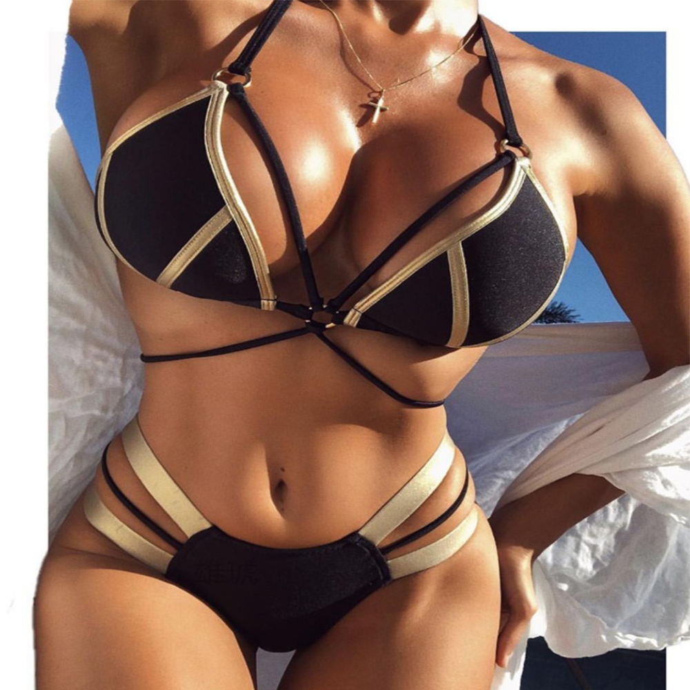 Person wearing a black and gold bikini set with a clear background